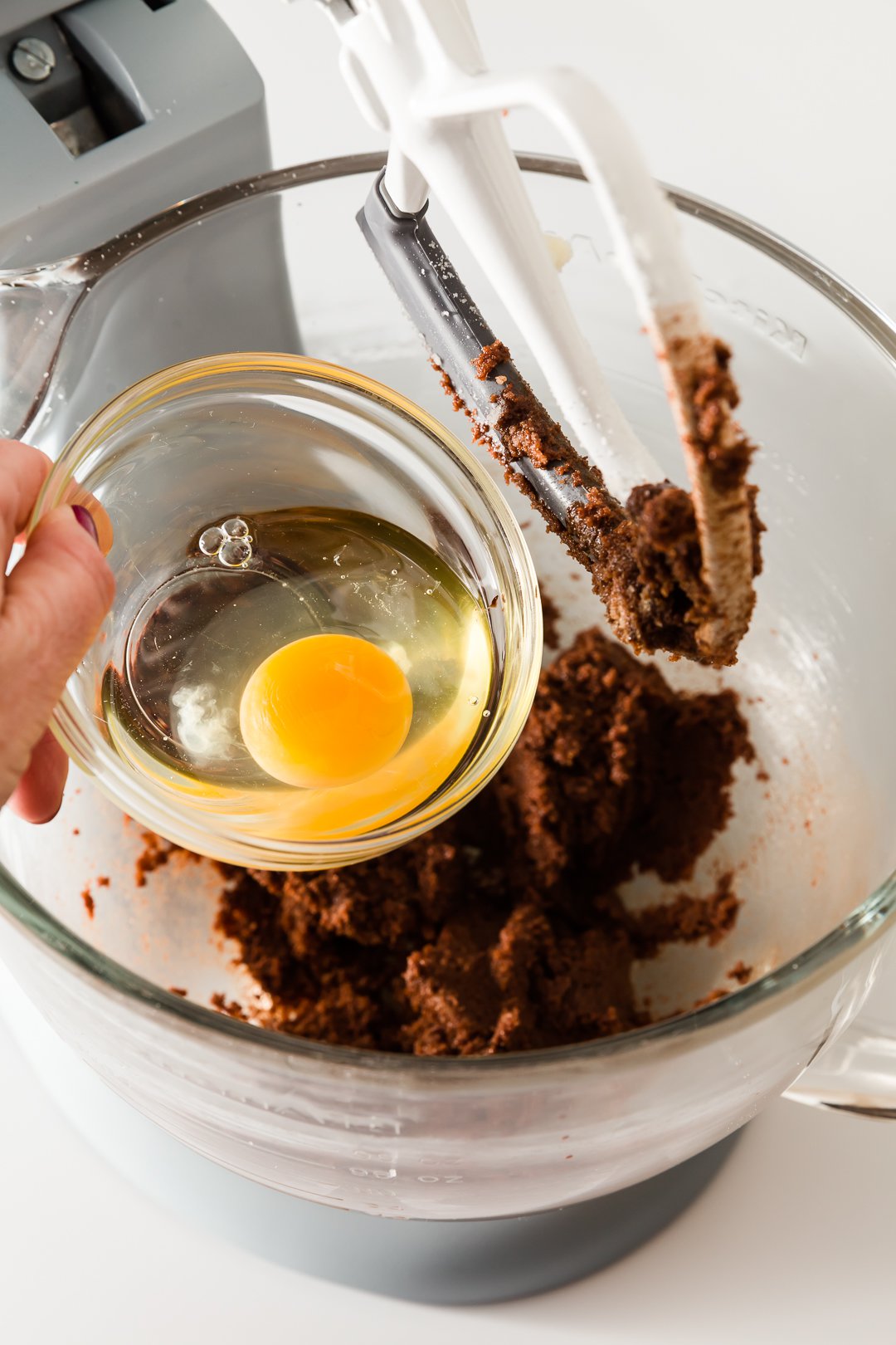 Adding eggs to chocolate cupcake batter