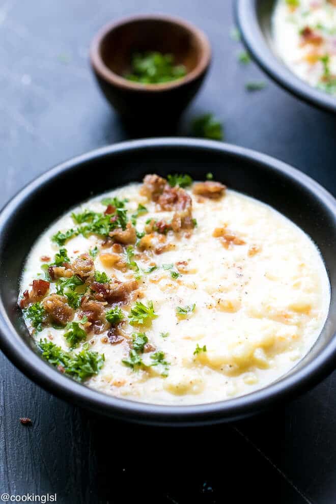Cauliflower Cheese Soup Low Carb Recipe - creamy, low fat , easy to make, delicious caulidflower cheddar soup in a bowl with parsley on the side.