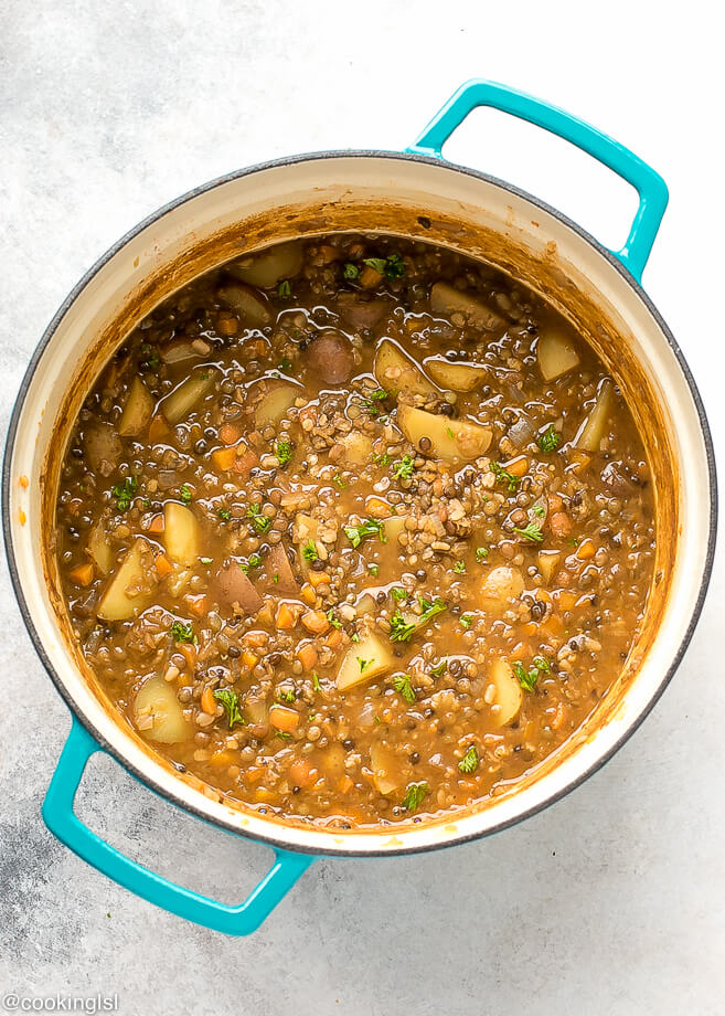Lentil Potato Soup Recipe. One pot nutritious brown lentil soup in a blue Dutch Oven.