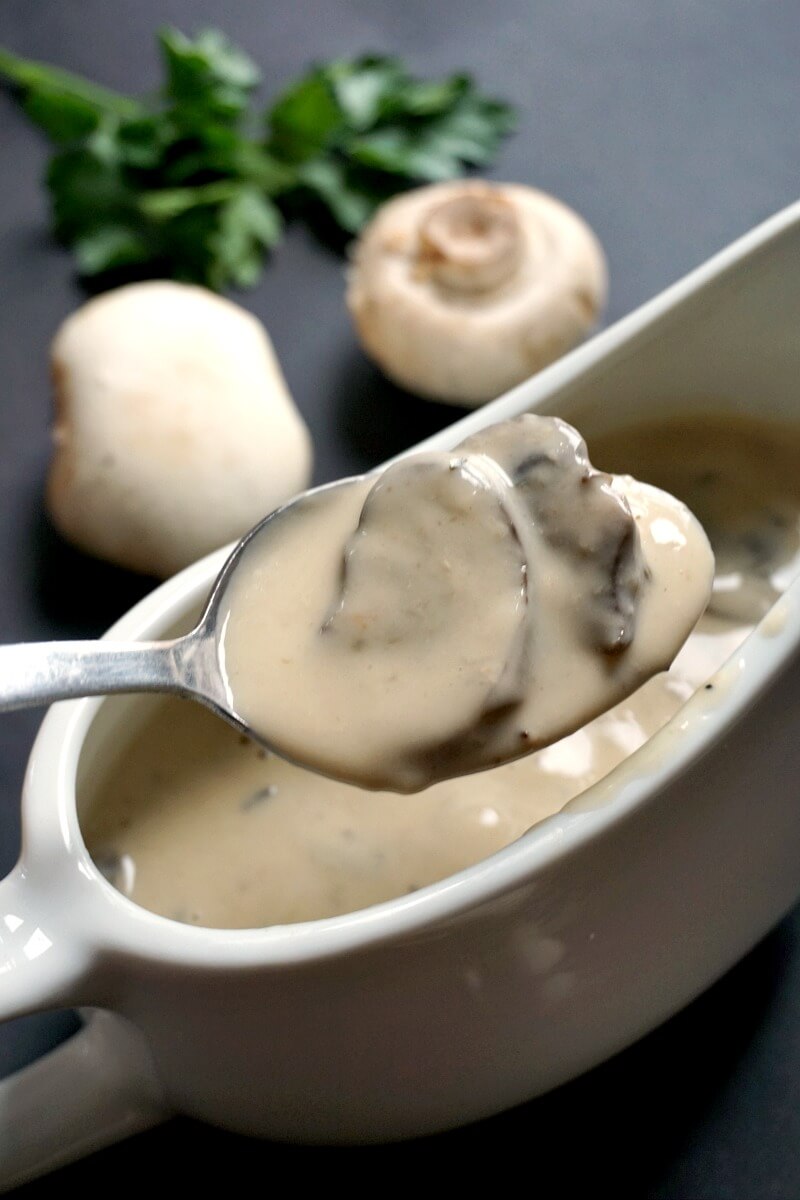 A white gravy bowl with creamy mushroom sauce for slow cooker muchroom chicken