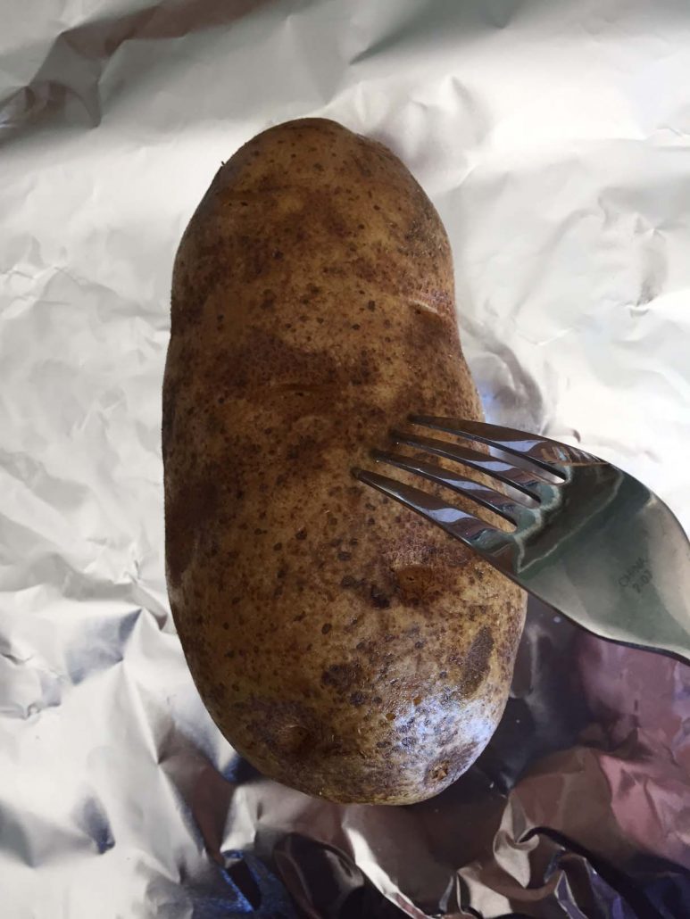 Prick potato with fork