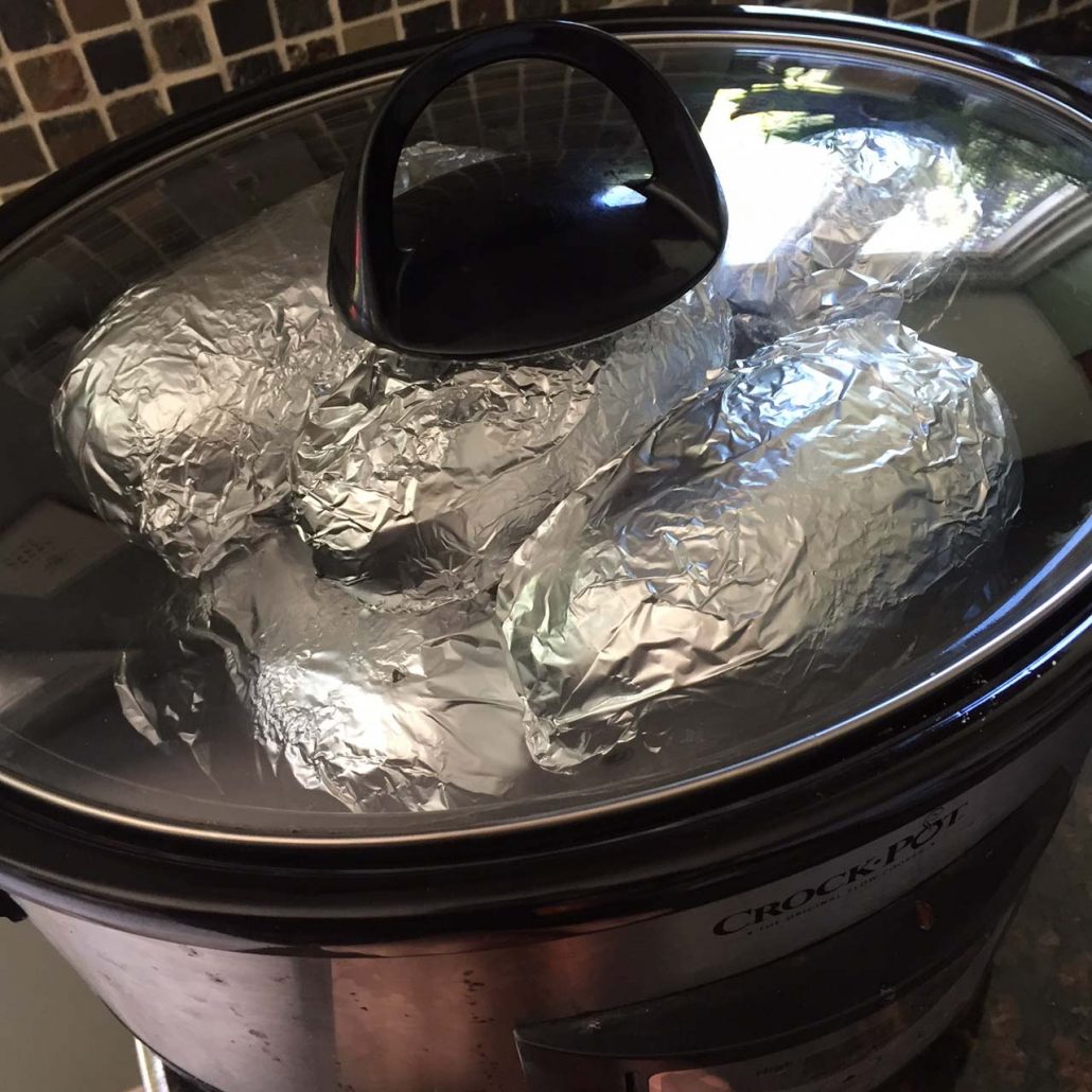 Crockpot With Foil Wrapped Baked Potatoes