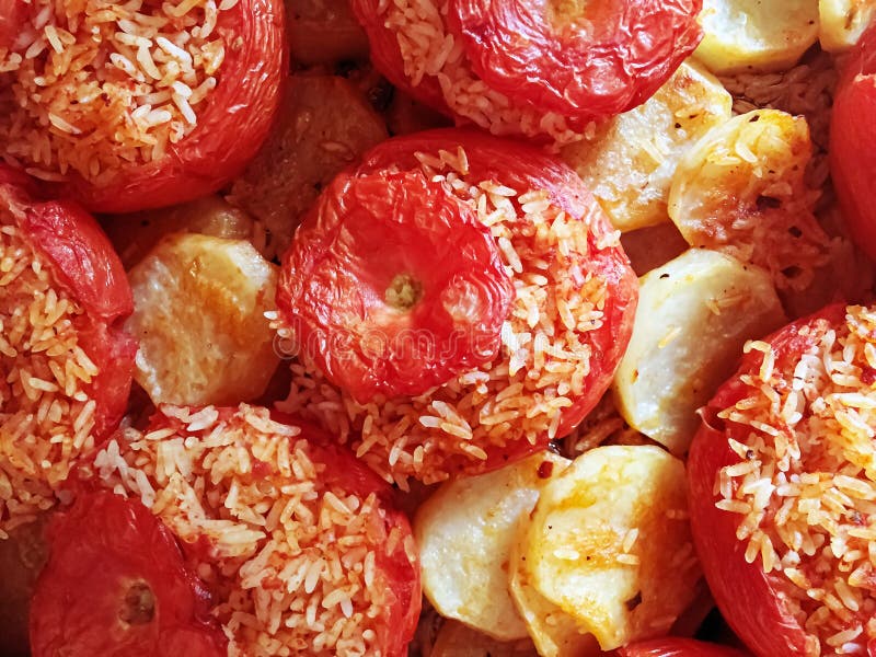 Baked tomatoes with rice and potatoes. Typical recipe of the Roman culinary tradition stock image