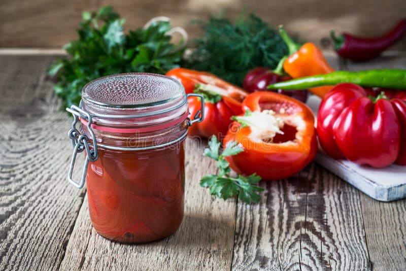 Pickled peppers in tomato juice stock photos