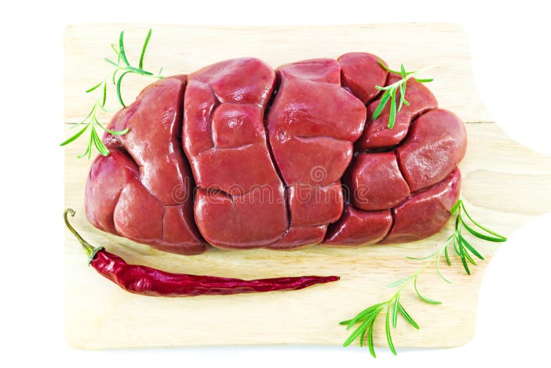 Raw beef kidney on a wooden cutting Board, isolated on a white background, close-up, meat offal. British meat dish stewed with ste royalty free stock photos