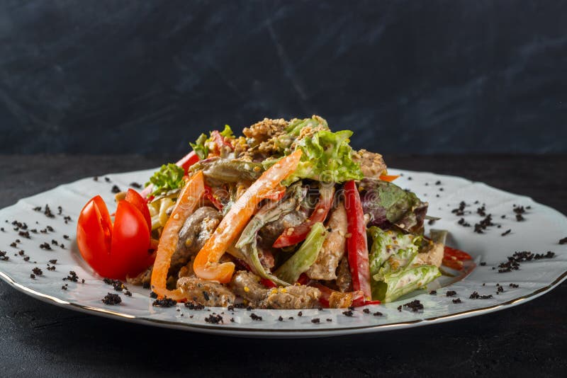 Salad of pickled cucumbers, bell peppers, chicken and sesame stock photos