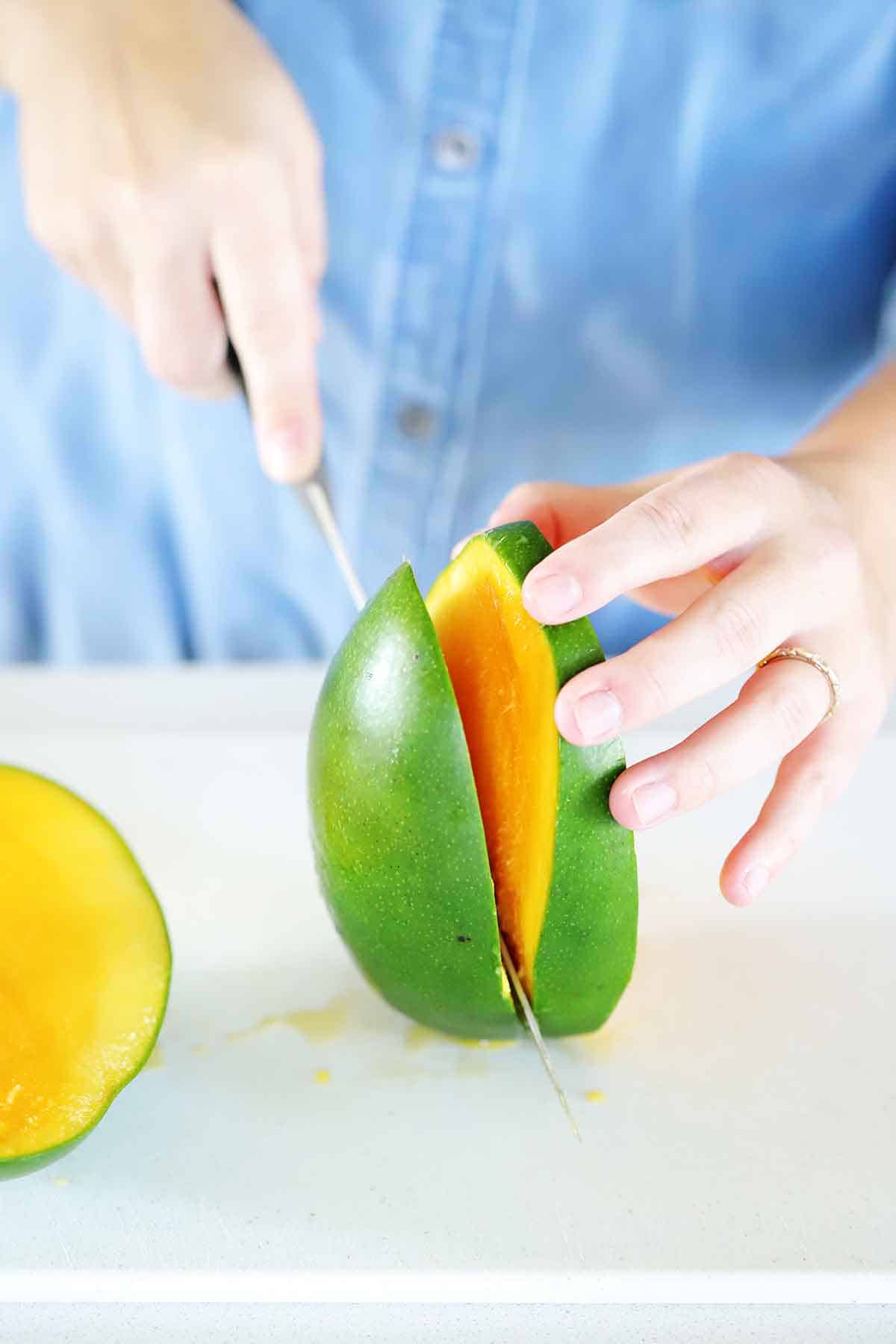 Slicing the sides off a mango