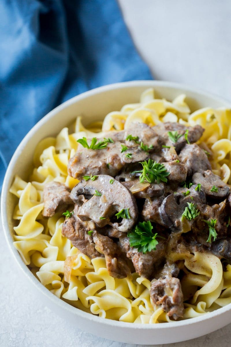 Slow Cooker Beef Stroganoff served over egg noodles