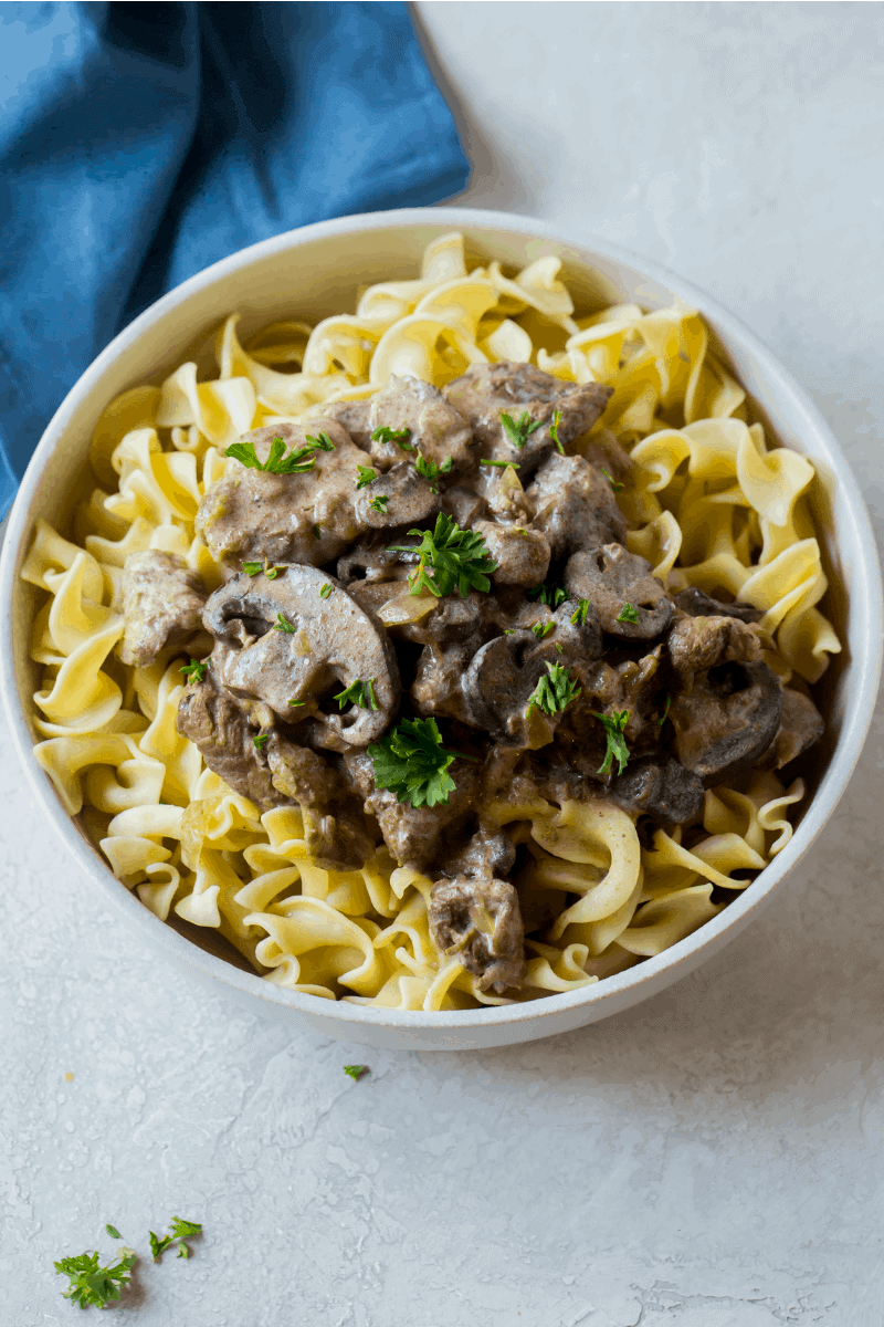 Slow Cooker Beef Stroganoff served over egg noodles