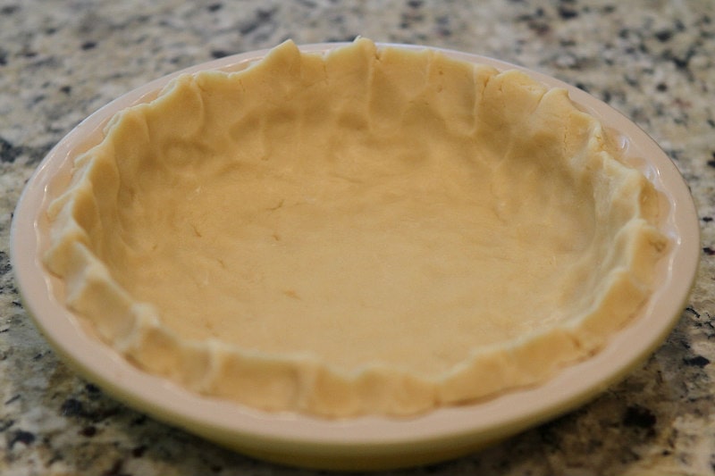 Cream Cheese Pie Crust pressed into a pie plate before baking